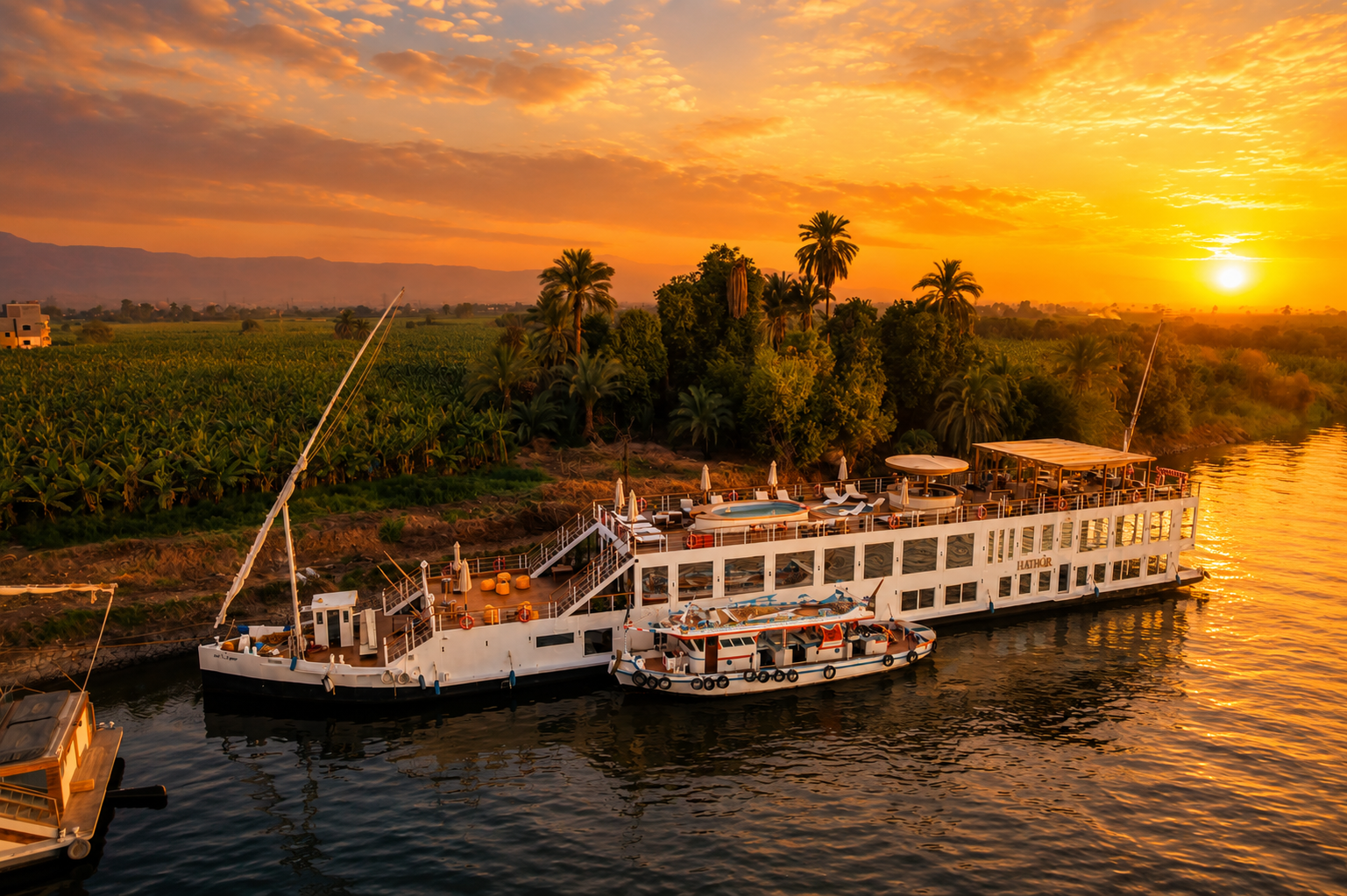 Hathor Dahabiya sailing at sunset
