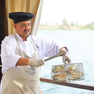 Chef preparing a meal aboard Queens by TIME