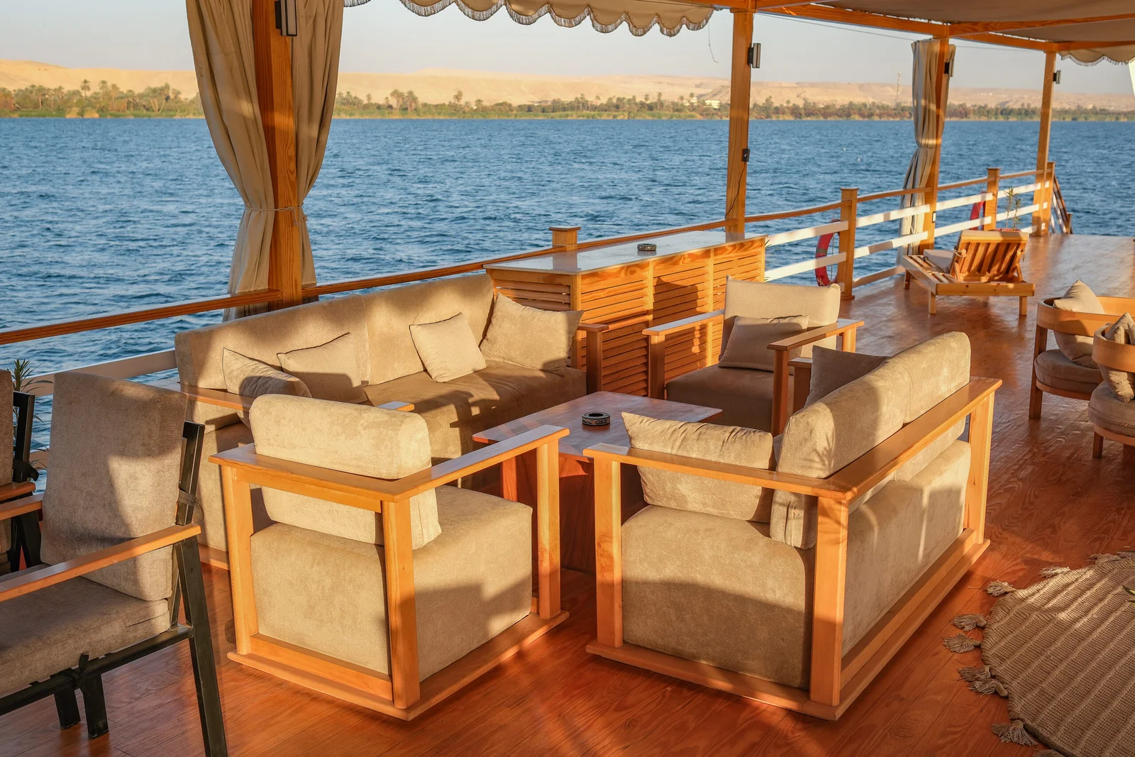 Swan Dahabiya outdoor lounge at sunset