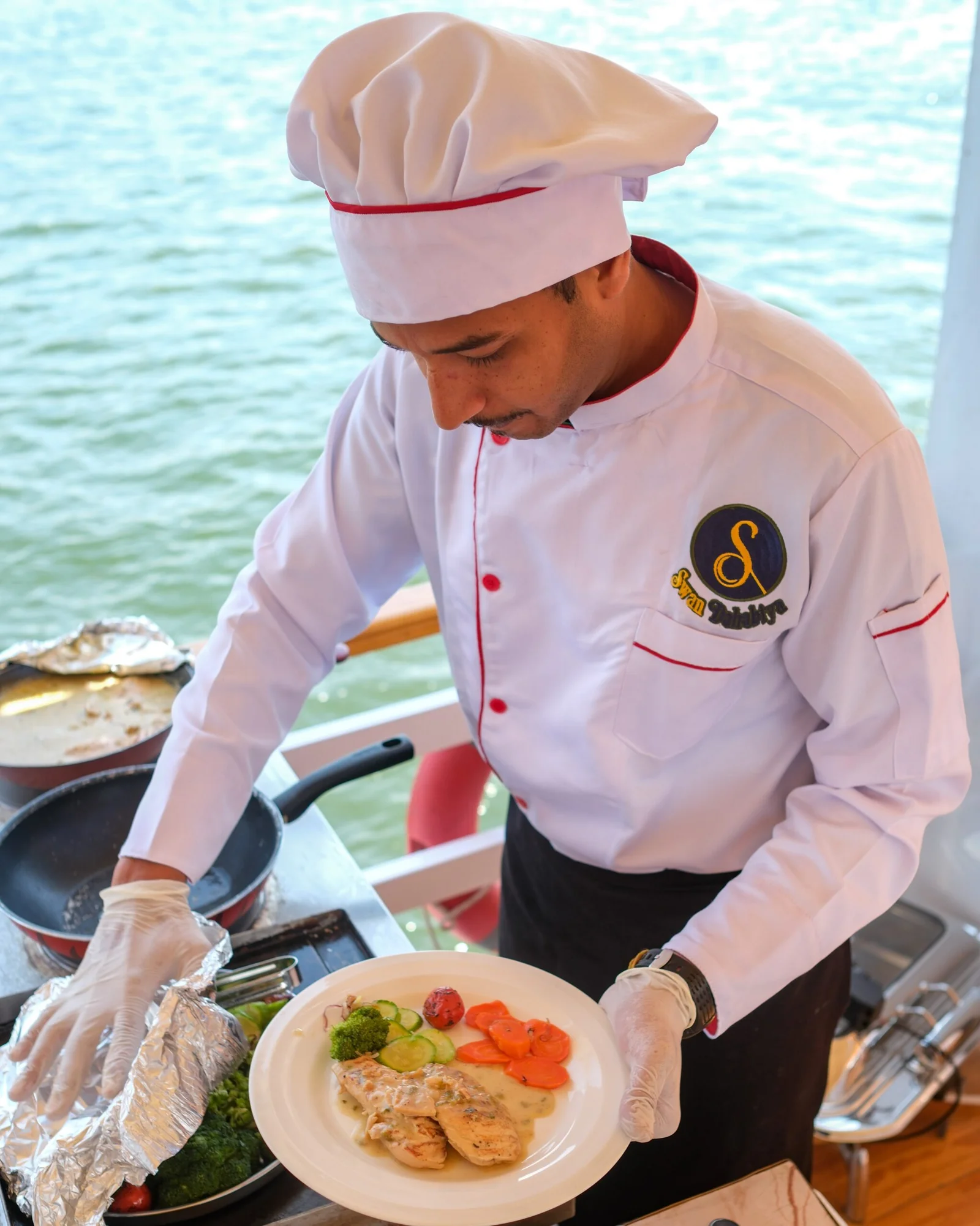 Chef serving onboard aboard Swan Dahabiya