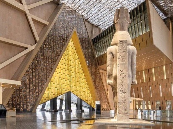 Man sitting on a Pharaonic throne between two Egyptian statues