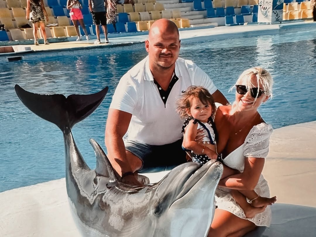 Family with dolphin photo