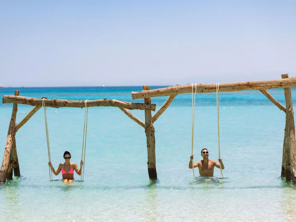 Sea swings in crystal clear shallow water
