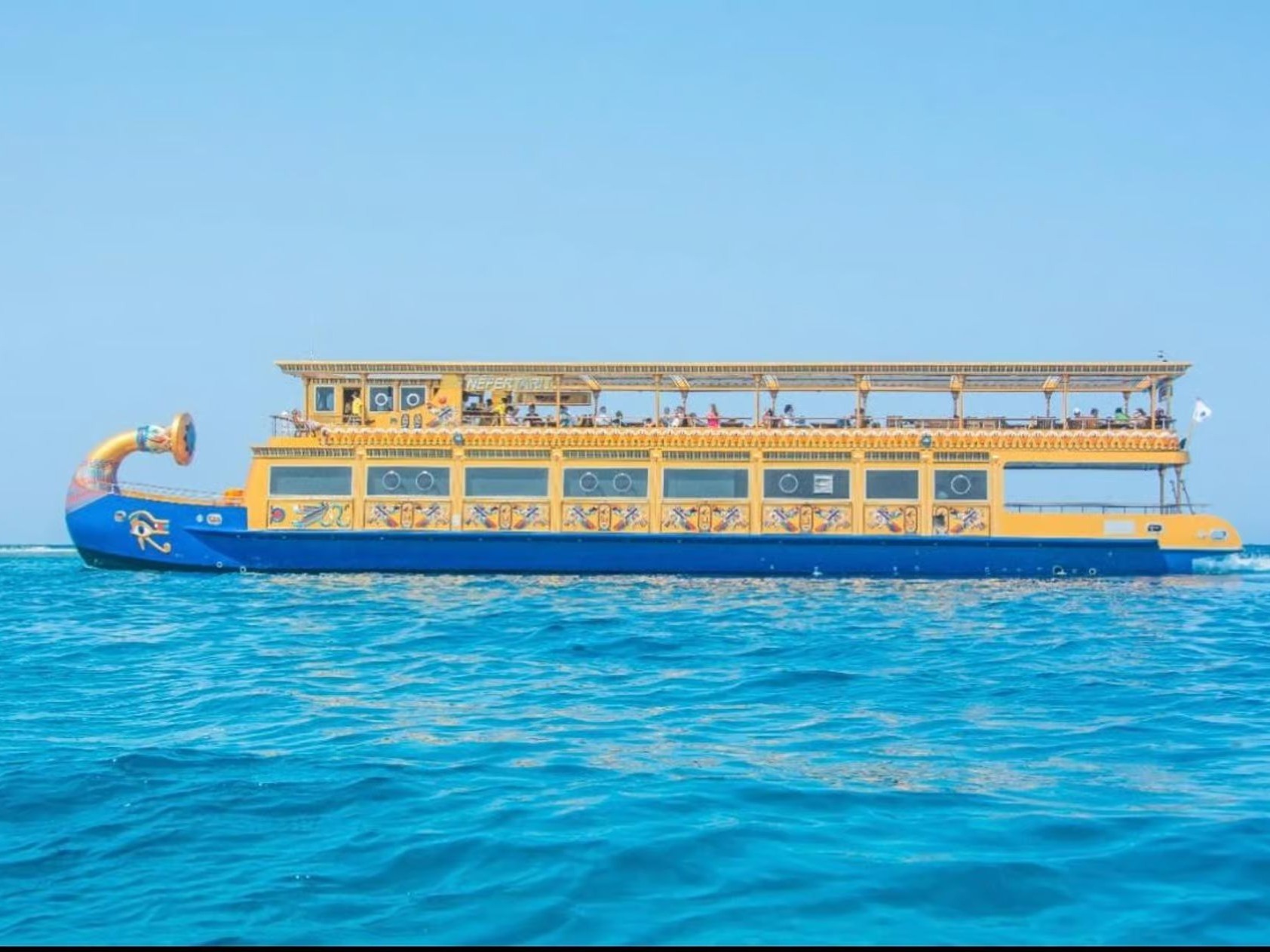 Side view of the Nefertari cruise ship on turquoise water