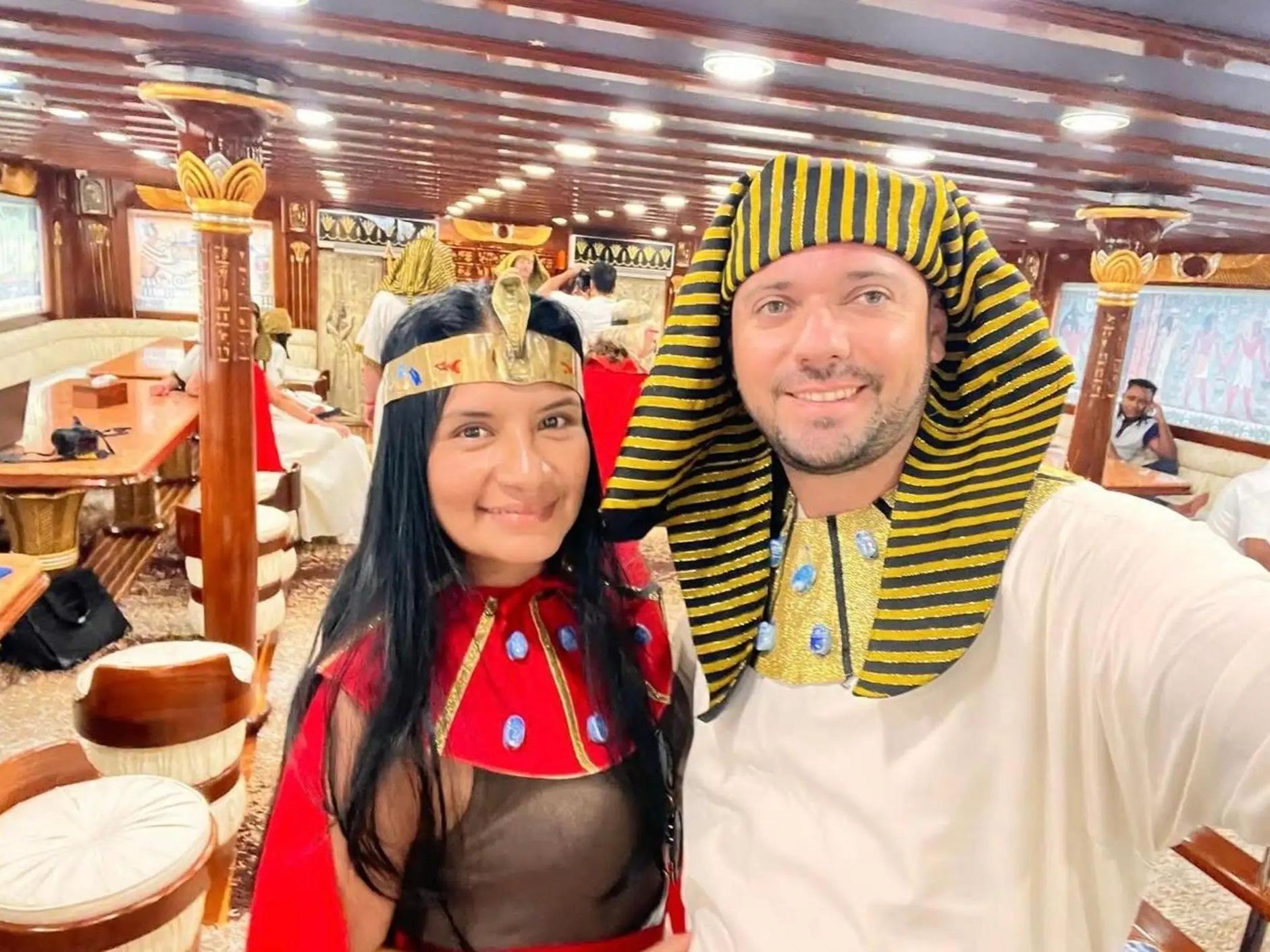 Couple dressed in Pharaonic attire smiling on the boat
