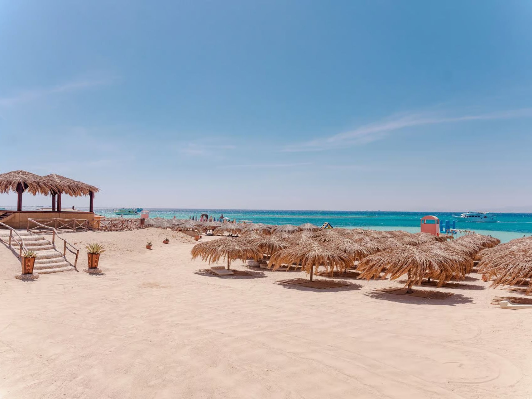 Private sandy beach with sun shades