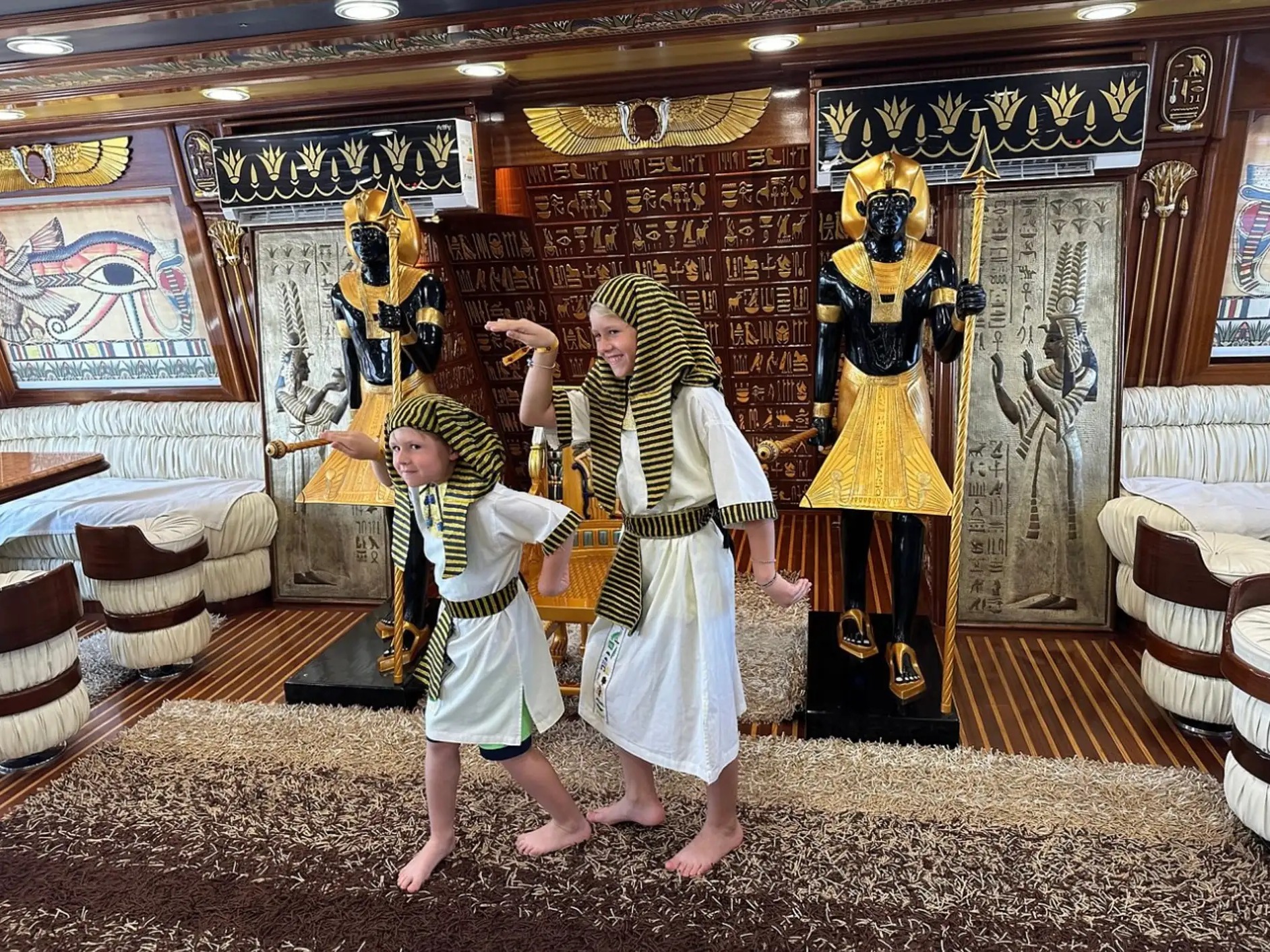 Children dressed in ancient Egyptian costumes inside the boat