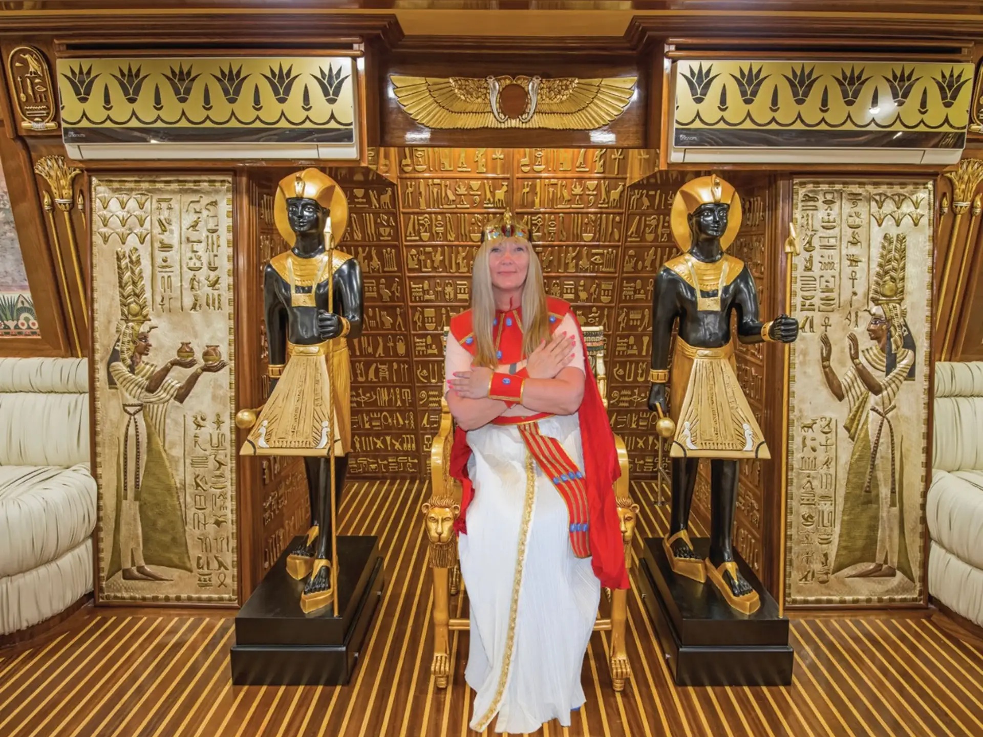 Guest dressed as ancient Egyptian queen posing inside themed interior