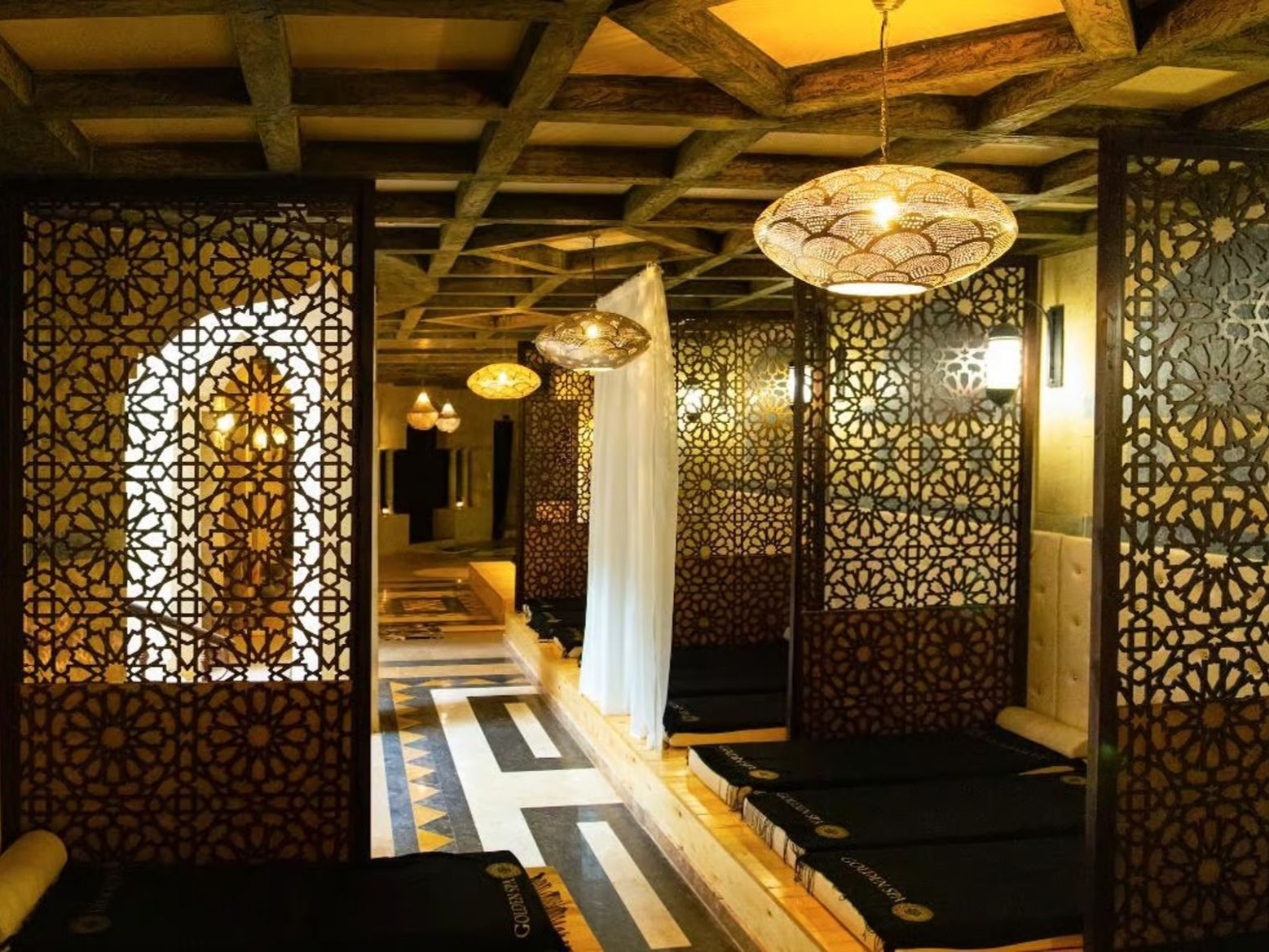 Traditional hammam interior with carved screens and lanterns