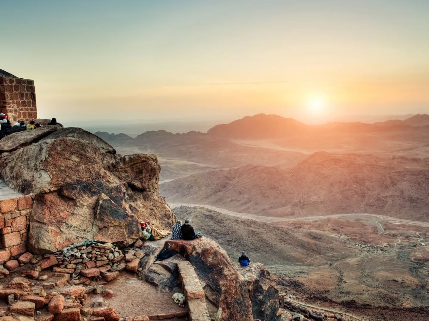 Man sitting on a Pharaonic throne between two Egyptian statues