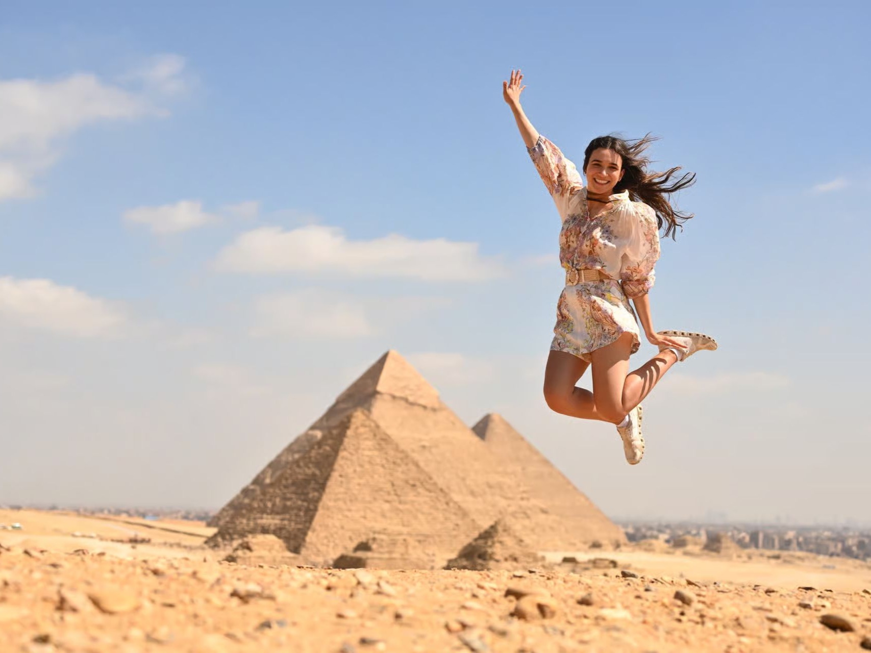 Tourist springt vor den Pyramiden von Gizeh